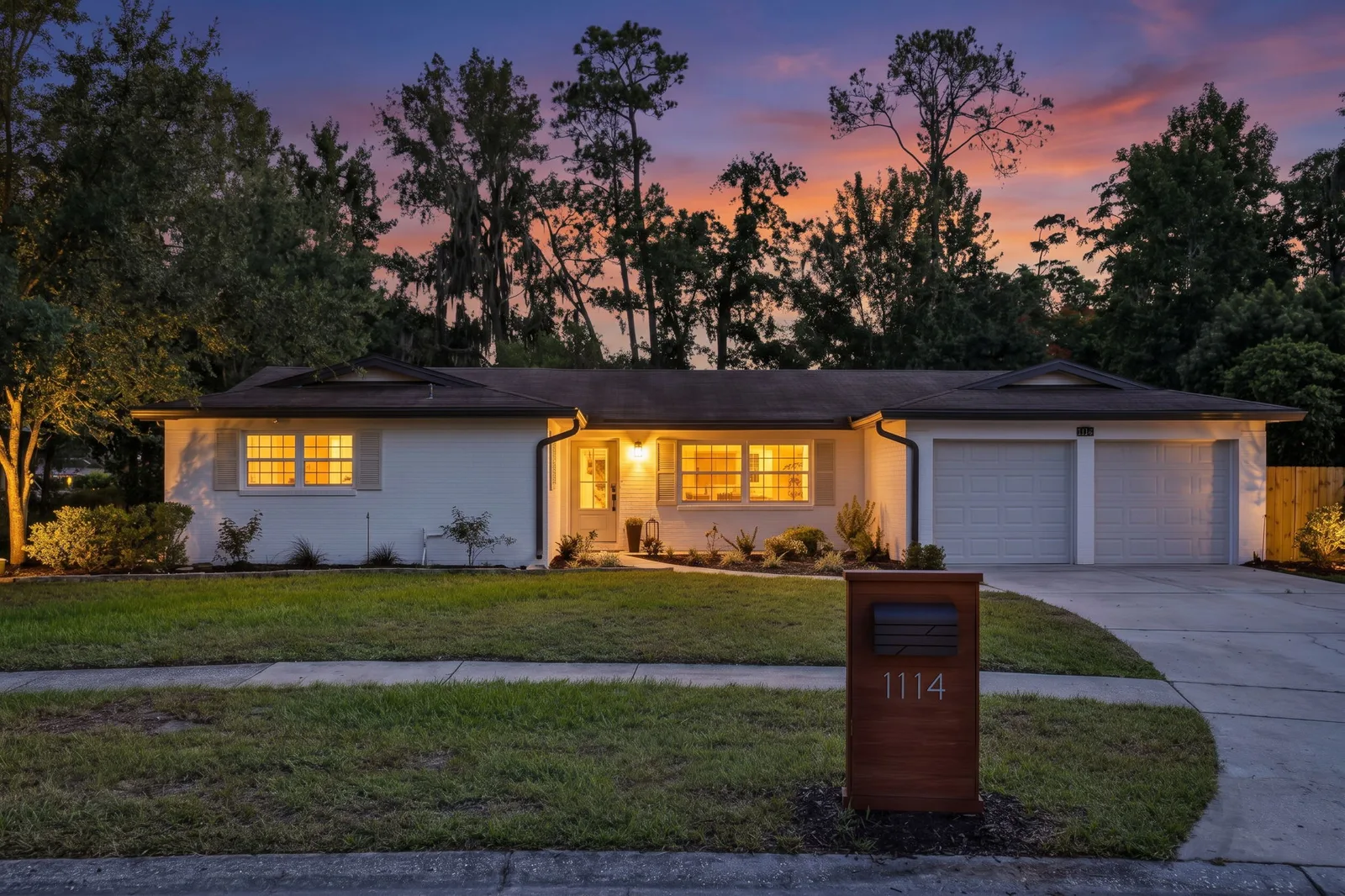 Twilight exterior photo of a white ranch-style home