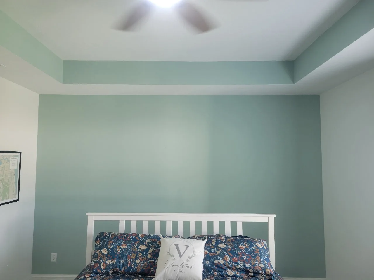 The same bedroom wall and tray ceiling detail finished in soft sage green