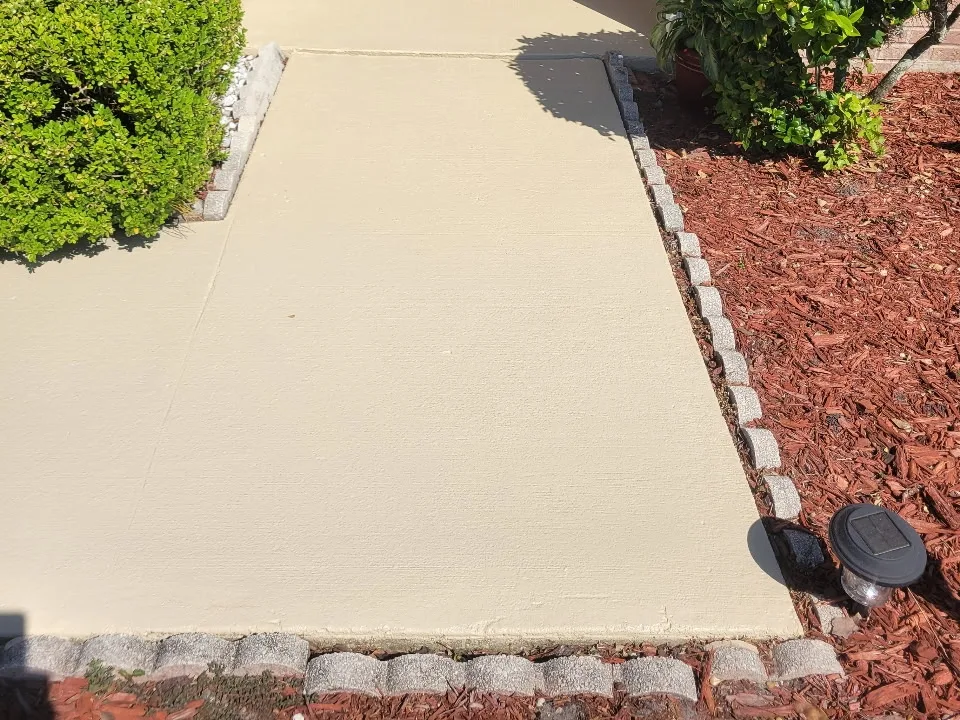 The same walkway finished in a smooth, warm tan coating