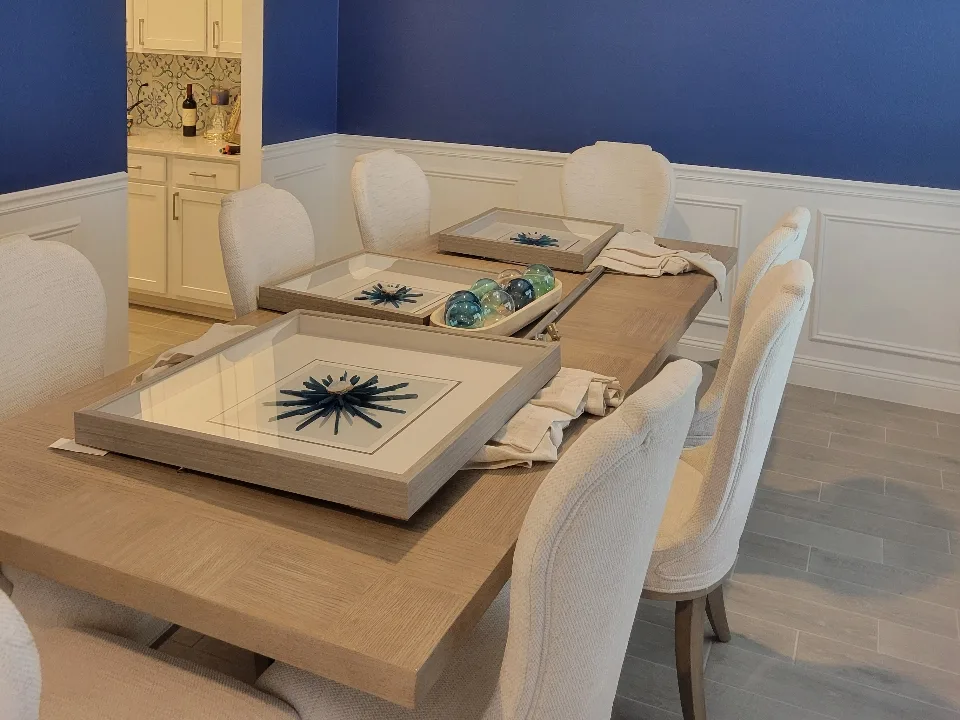The same dining room wall finished in bold cobalt blue above white wainscoting