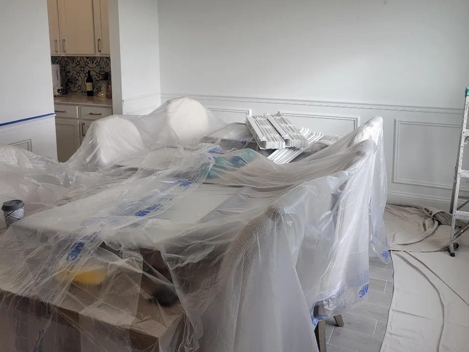 Plain white dining room wall and wainscoting before painting