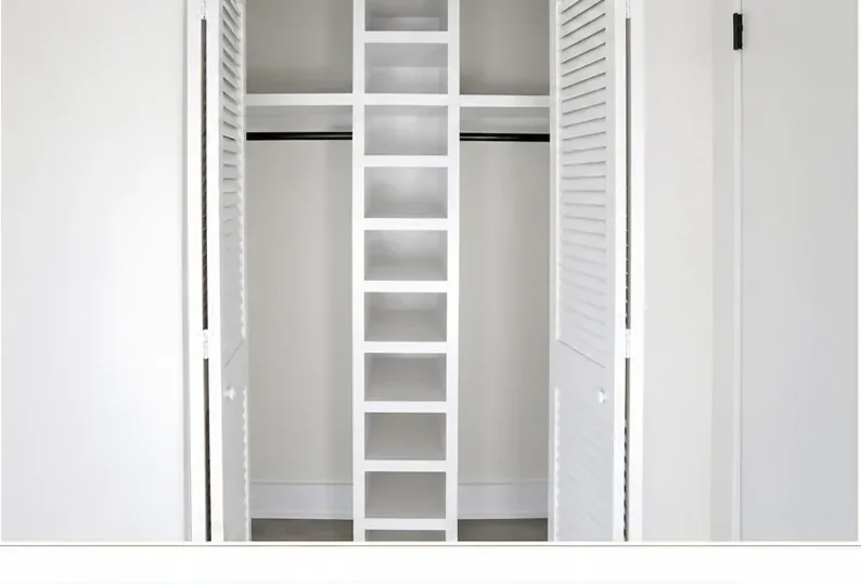 The same closet finished in crisp white with freshly painted louvered doors