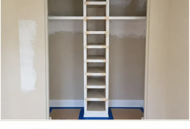 Patched tan closet interior with bare shelving before painting