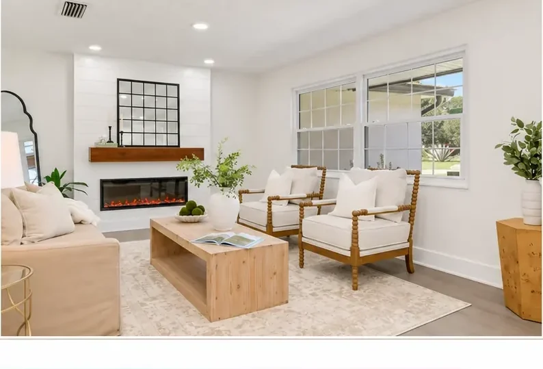 The same living room finished in bright white with a shiplap fireplace feature and light staging