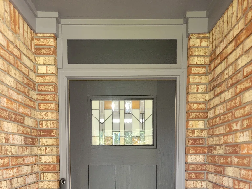 The same entry finished with a slate blue-gray door and freshly painted brick mortar
