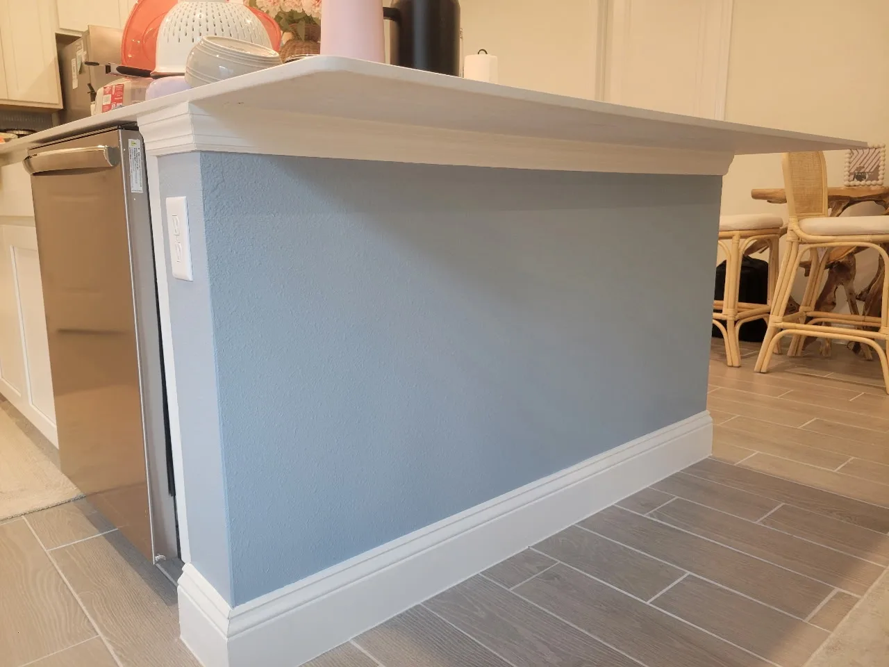 The same kitchen island finished in soft blue-gray